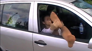Feet dangling out of car window