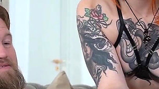 A Tattooed Redhead Gives a Loser a Handjob