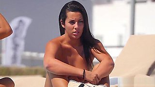 Perfect tanned babe show off her tits on the beach