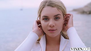 Blonde beauty Little Caprice and brunette Gabbie Carter share a massive cock on a sunny beach