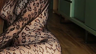 I'm Posing in a Black Fishnet Bodysuit and Heels, Pleasuring Myself with My Fingers.