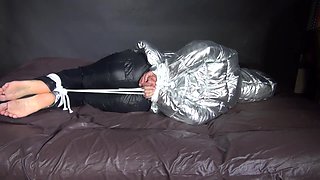 Watching Sexy Sandra Being Tied And Gagged On A Bed With Ropes And A Ballgag Wearing A Supersexy Shiny Black Nylon Pants And A Silver Down Jacket (Video)