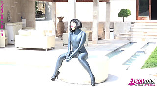 Naked Rubber Doll Relaxing by the Pool
