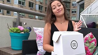 Funny brown haired girl in dark-hued top on balcony