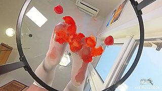 My Nylon Feet Squeezing Strawberry Juice on a Glass Table