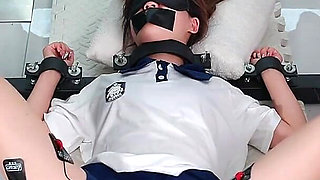 The Girl in a Metal Fixed Position, Legs Spread and Barefoot, Trembling to Climax