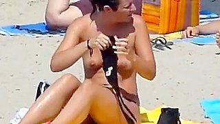 Beach 02 - A topless gril and her large boobs ally