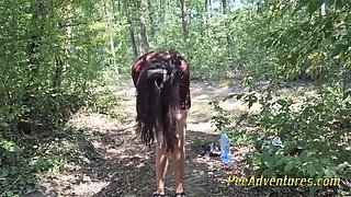 Amateur girl strips nude in forest clearing and empties her full bladder in HD