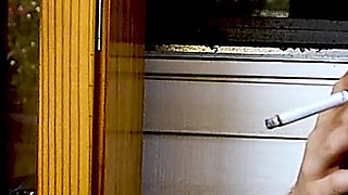 Shaved Head Goth Smokes Outside