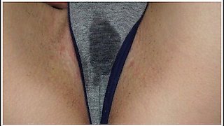 Wet panties betray her arousal as she touches herself