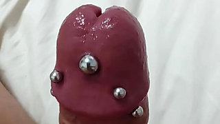 Pierced cock cumming with toy